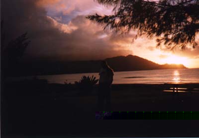 Photo
of Steve's dark silohette cast against brillient orange and pink clouds.