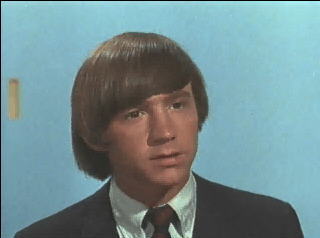Peter talking to the machine at the toy company in "Monkee vs. Machine"