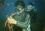 Loran Zammit holding a starfish, overlooked by Fabian