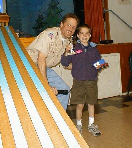 Cubmaster and son in victory