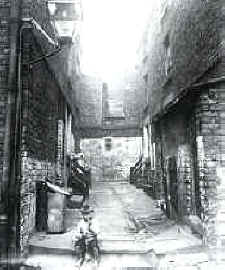 A kid of the courts ---note the bare feet and gas lamp on the left