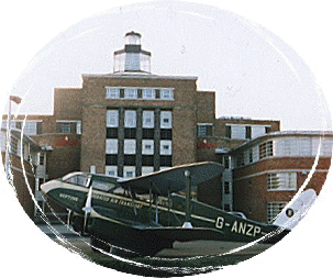 Dragon rapide stands at art-deco frontage of the old Liverpool airport
